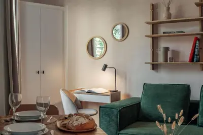 a living room with a green chair and a table at Casa Atrio - Wonderful studio near Barcelona cathedral in Barcelona