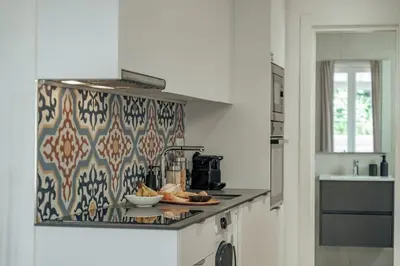 a kitchen with a counter with a pattern on the wall at Casa Atrio - Wonderful studio near Barcelona cathedral in Barcelona