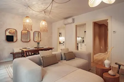 a living room with a couch and a table and mirrors at Casa Calders in Barcelona