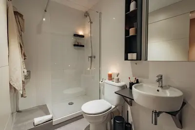 a bathroom with a toilet and a sink and a shower at Casa Calders in Barcelona