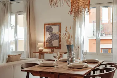 a living room with a table and a couch at Casa Calders in Barcelona