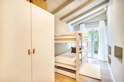 a bedroom with bunk beds in a house at Villa Atardecer in Barcelona