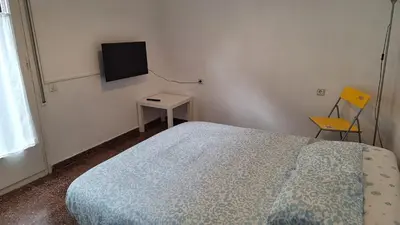 a bedroom with a bed and a tv on the wall at La Garsa in Aiguafreda