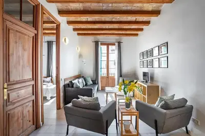 a living room with two chairs and a table at Mooeve Sant Antoni in Barcelona