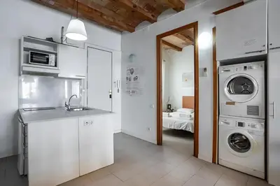 a kitchen with a washing machine and a washer and dryer at Mooeve Sant Antoni in Barcelona
