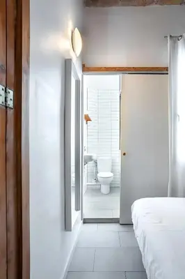 a bedroom with a bathroom with a toilet and a sink at Mooeve Sant Antoni in Barcelona
