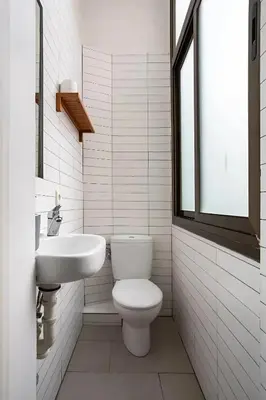 a white bathroom with a toilet and a sink at Mooeve Sant Antoni in Barcelona