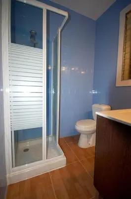 a bathroom with a toilet and a glass shower at Lets Holidays Apartment Barcelona near beach in Barcelona