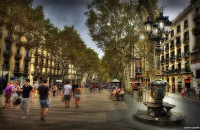 a group of people walking down a busy city street at Lets Holidays Apartment Sea Views in Barcelona in Barcelona