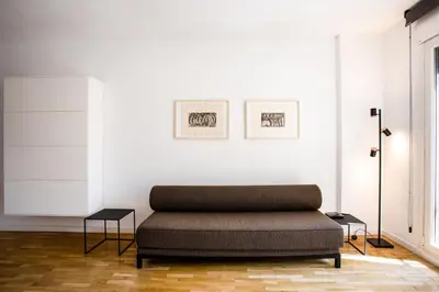 a living room with a couch and two tables at Suitur apartamento exclusivo céntrico Barcelona in Barcelona