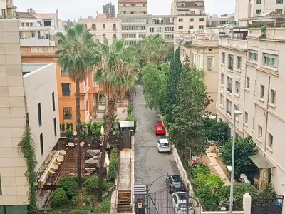 a city street with palm trees and buildings at Suitur apartamento exclusivo céntrico Barcelona in Barcelona