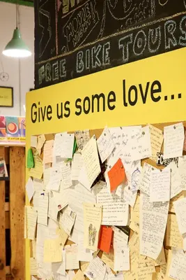 a bulletin board with a sign that says free tours give us some love at Bed & Bike Barcelona in Barcelona