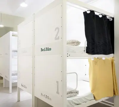 a room with two bunk beds and a closet at Bed & Bike Barcelona in Barcelona