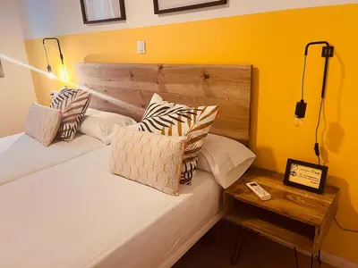 a bedroom with a bed with pillows and a table at Bed & Bike Barcelona in Barcelona