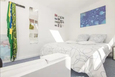 a white bedroom with a bed and a mirror at Terrace Duplex at Sagrada Familia by PriorityVillas in Barcelona
