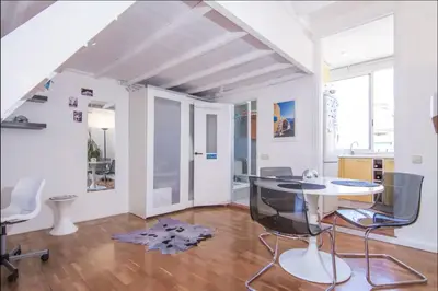 a living room with a glass table and chairs at Terrace Duplex at Sagrada Familia by PriorityVillas in Barcelona