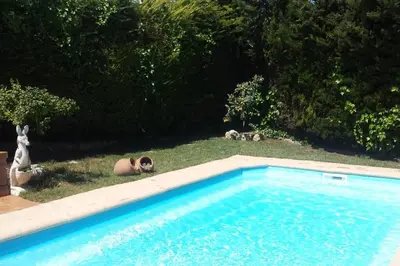 a backyard with chairs and a swimming pool at Beach villa with pool and near BCN & TGN in Cunit