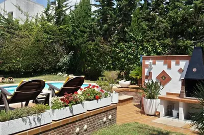 a living room with a couch and a tv at Beach villa with pool and near BCN & TGN in Cunit