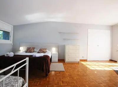 a bedroom with a bed and a dresser at Torre Vendrell con Padel in Sant Pere de Vilamajor