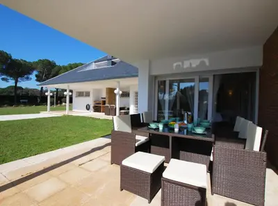 a patio with a table and chairs and a yard at Torre Vendrell con Padel in Sant Pere de Vilamajor