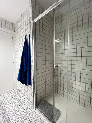 a shower with a glass door in a bathroom at Espectacular Sunny House in the beach in Cunit