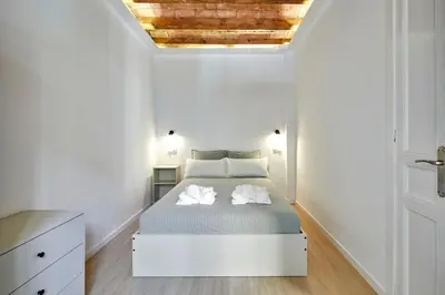 a bedroom with a bed with two towels on it at Stylish typical BCN flat in Barcelona