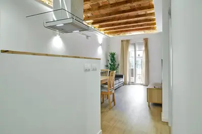 a kitchen and dining room with a ceiling fan at Stylish typical BCN flat in Barcelona