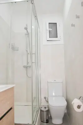 a bathroom with a glass shower and a toilet at Apartamento Gaudí-Sant Pau in Barcelona