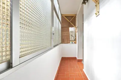 a hallway with a window and a brick floor at Vibrant and modern apartment in Barcelona
