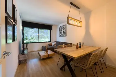 a dining room with a wooden table and chairs at The Lonely Chimney Apartments in Barcelona