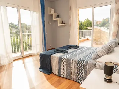 a bedroom with a bed and a large window at Casa Serenidad: Naturaleza, Jacuzzi & Parking en Cubelles - ES-332-10 in Cubelles