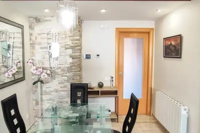 a dining room with a glass table and chairs at Fee4Me Comfortable flat near the sea in Sant Adria de Besos