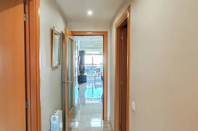 a hallway with a view of a pool in a building at Fee4Me Comfortable flat near the sea in Sant Adria de Besos