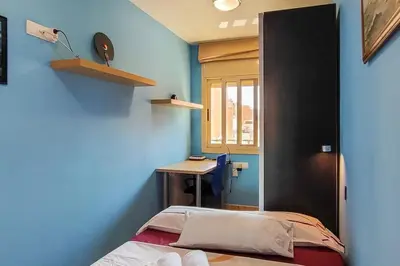a room with a bed and a desk in it at Fee4Me Comfortable flat near the sea in Sant Adria de Besos