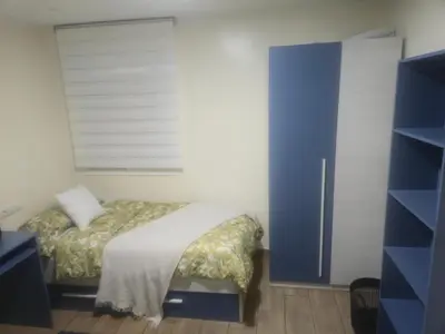 a bedroom with a bed and a blue door at Apartamento Moderno, amplio y muy cómodo in Terrassa
