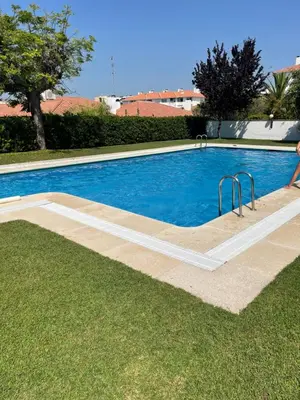a swimming pool in the middle of a yard at Viva Sitges - Sitges View in Sitges