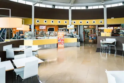 a restaurant with tables and chairs in a store at AS Porta de Barcelona in Castellbisbal