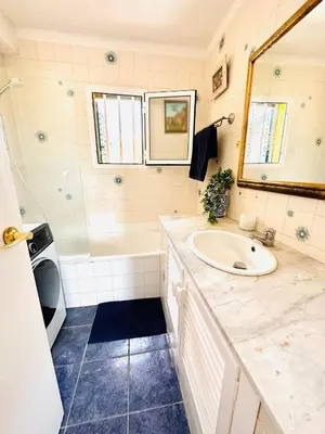 a bathroom with a sink and a tub and a mirror at Solaui in Esplugues de Llobregat