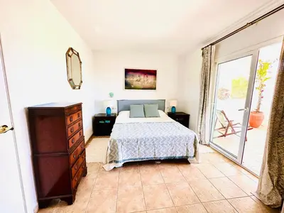 a bedroom with a bed and a large window at Solaui in Esplugues de Llobregat