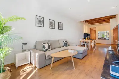 a living room with a couch and a table at Lodging Apartments Entenca in Barcelona