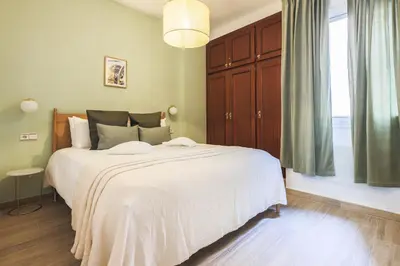 a bedroom with a large white bed and a window at Stay U-nique Apartments Sant Nicolau in Barcelona