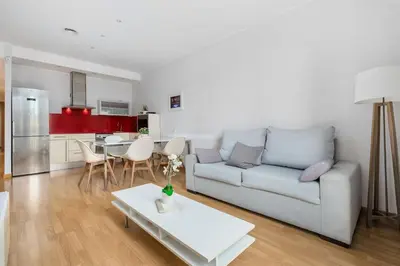 a living room with a couch and a table at Flateli Pelayo H2 in Barcelona