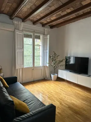 a living room with a couch and a flat screen tv at Dudu life in Barcelona