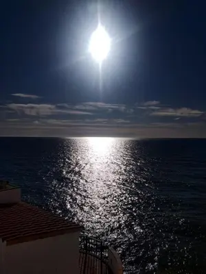 a view of the ocean with the sun in the sky at Loft espectacular vista al mar in Sitges