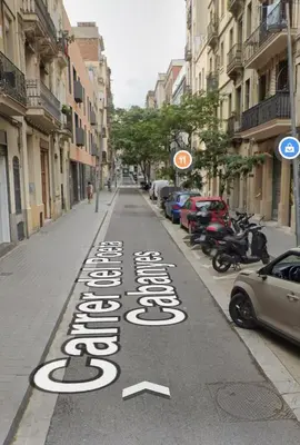 a street with a sign on the road at Casa a pasos de Las Ramblas in Barcelona