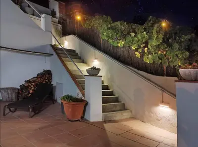 a staircase with plants on the side of a building at Apartamento en medio de la naturaleza, con fantásticas vistas in Sant Cugat del Vallès