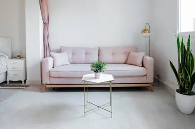 a living room with a pink couch and a table at Magic Apartment with Private Terrace in Barcelona