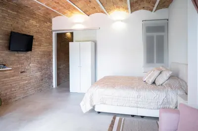 a bedroom with a bed and a brick wall at Magic Apartment with Private Terrace in Barcelona