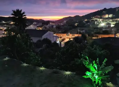 a view of a city at night at Casa con piscina uso privado in Cunit