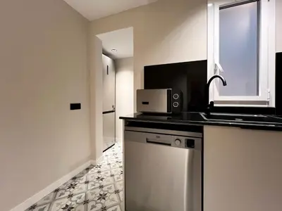 a kitchen with a sink and a microwave on a counter at Stay U-nique Apartment Castanyer in Barcelona